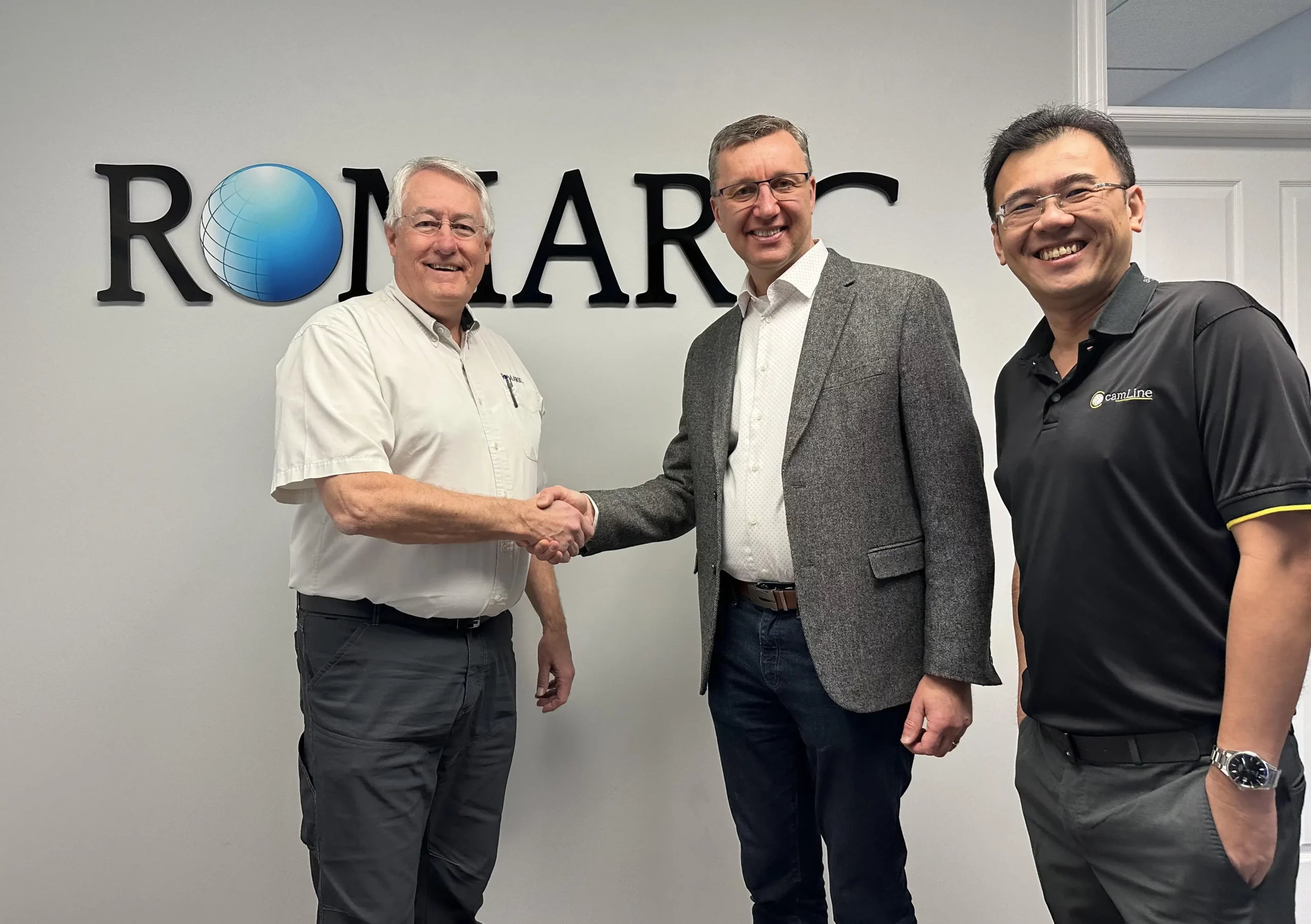 Rory Gagon, CEO and founder of Romaric (left) shaking hand with Henri Korpi, Executive Vice President of Elisa International Digital Services (middle), with Bryan Ng, CEO of camLine (right) standing on the side.
